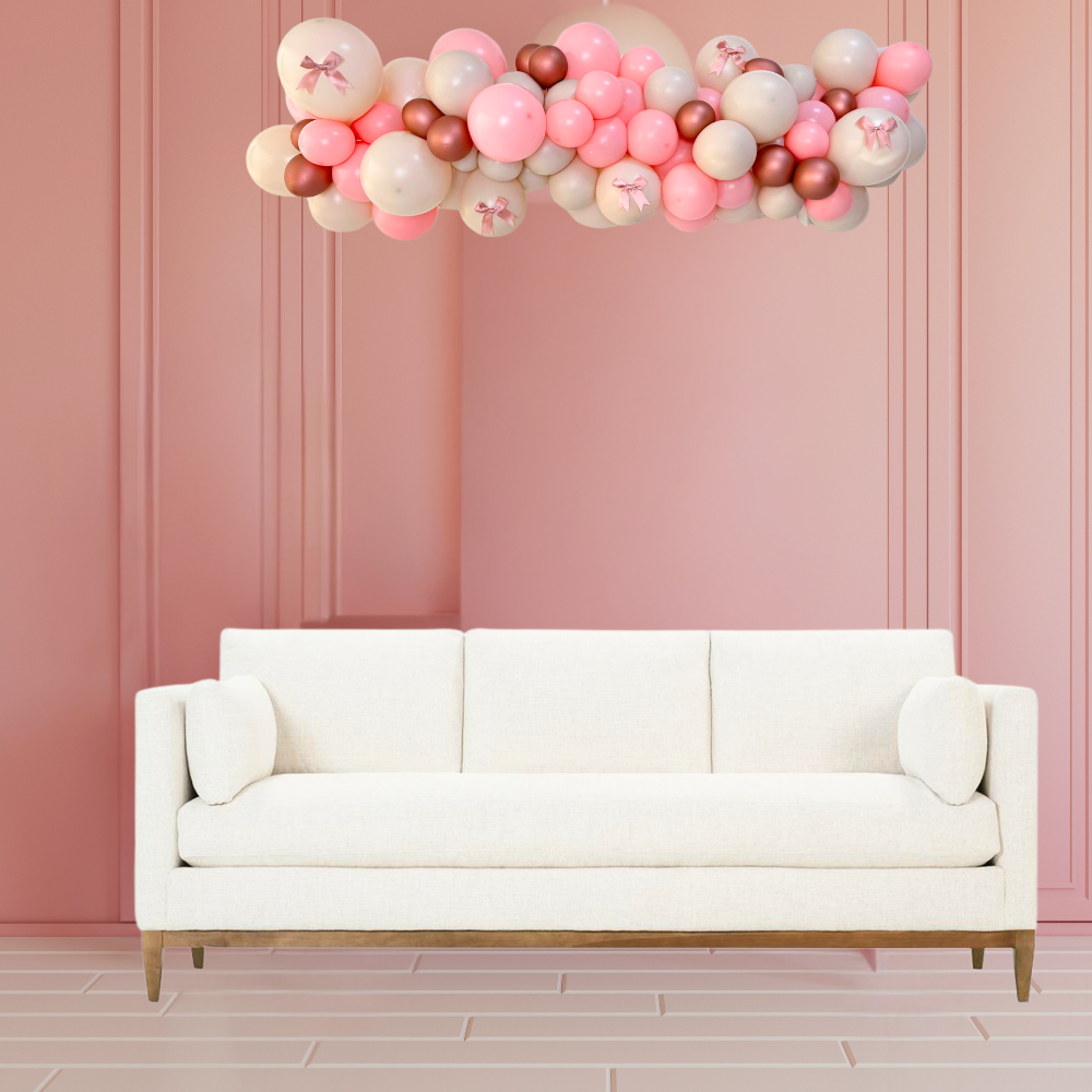 Customize Inflated Balloon Garland-1.5m displayed on a white couch, featuring pink and white balloons, ideal for enhancing party decor with ease.