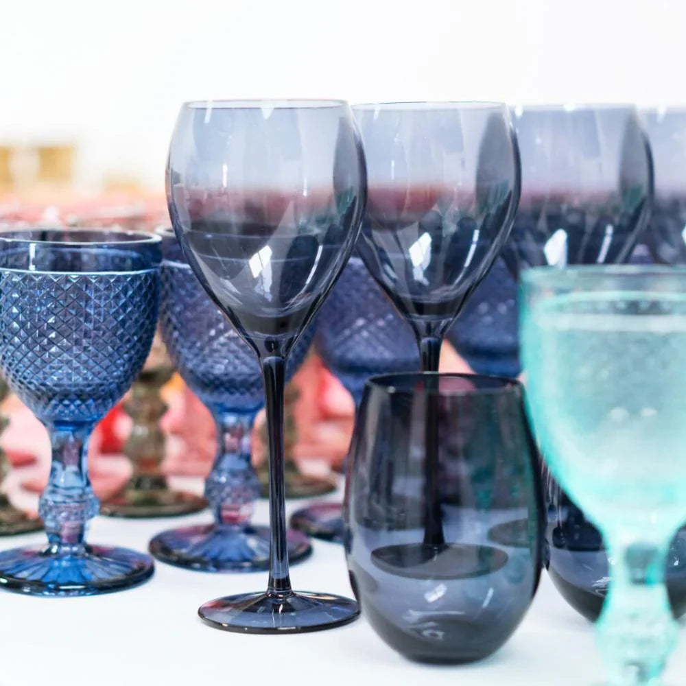 Collection of different colors of glassware on a table