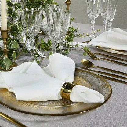 Crystal Rome Glassware Collection: Elegant table setting featuring crystal goblets and wine glasses with detailed stems, complemented by gold flatware and a charger plate.