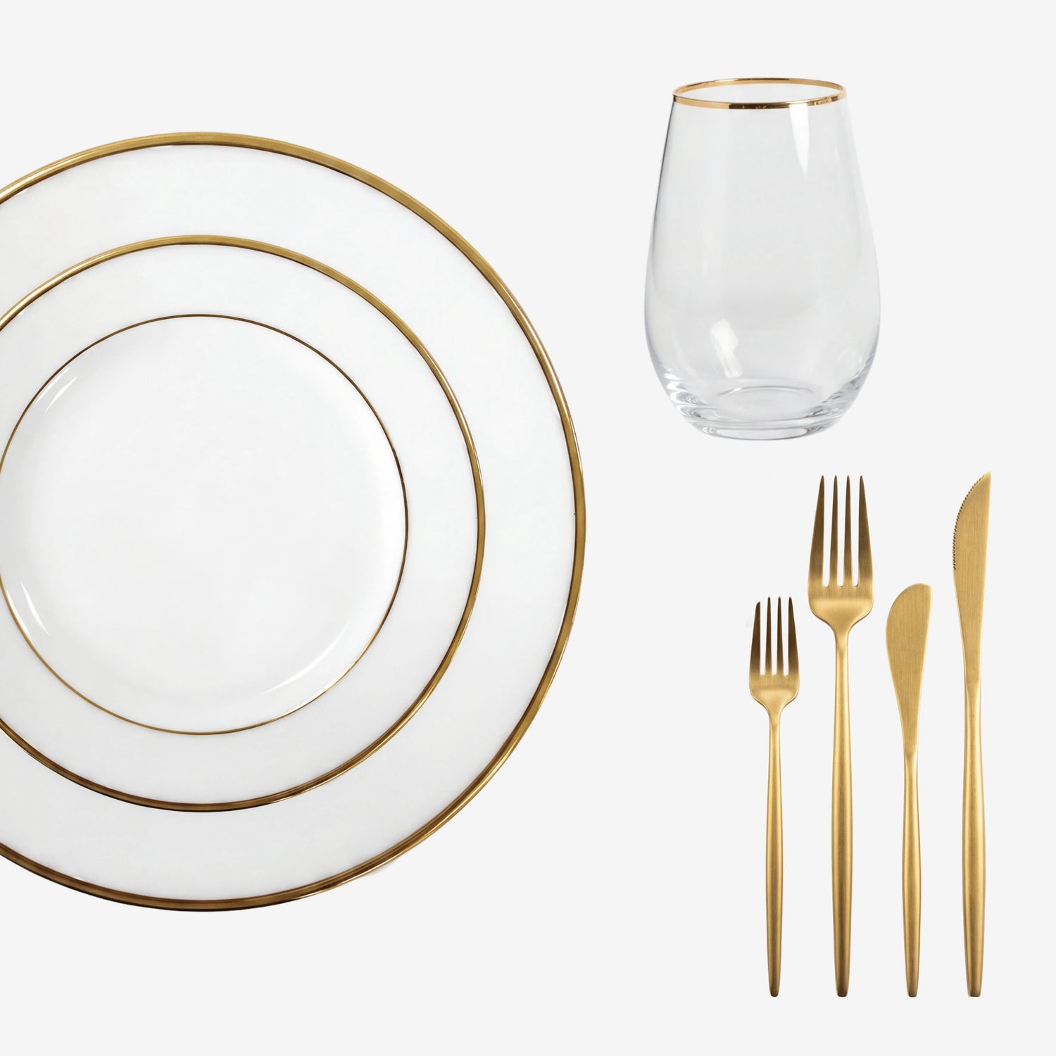 Gold Lined Tabletop Package: Elegant white plates, gold-rimmed tumbler, and gold-tone flatware, ideal for sophisticated dining experiences from Party Social.