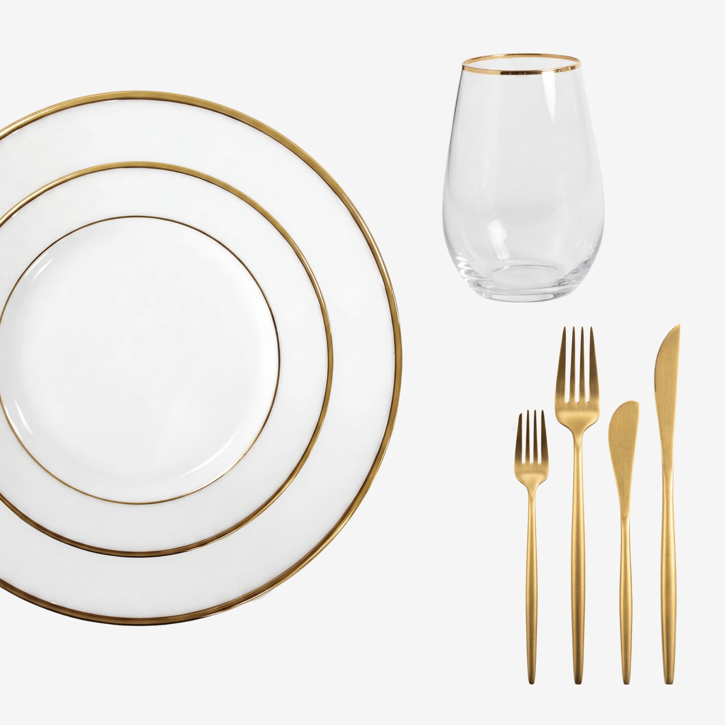 Gold Lined Tabletop Package: Elegant white plates, gold-rimmed tumbler, and gold-tone flatware, ideal for sophisticated dining experiences from Party Social.