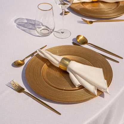 CHARGER PLATE - GOLD LINED elegantly set with gold flatware and glasses, exemplifying refined table decor for special occasions or everyday luxury.