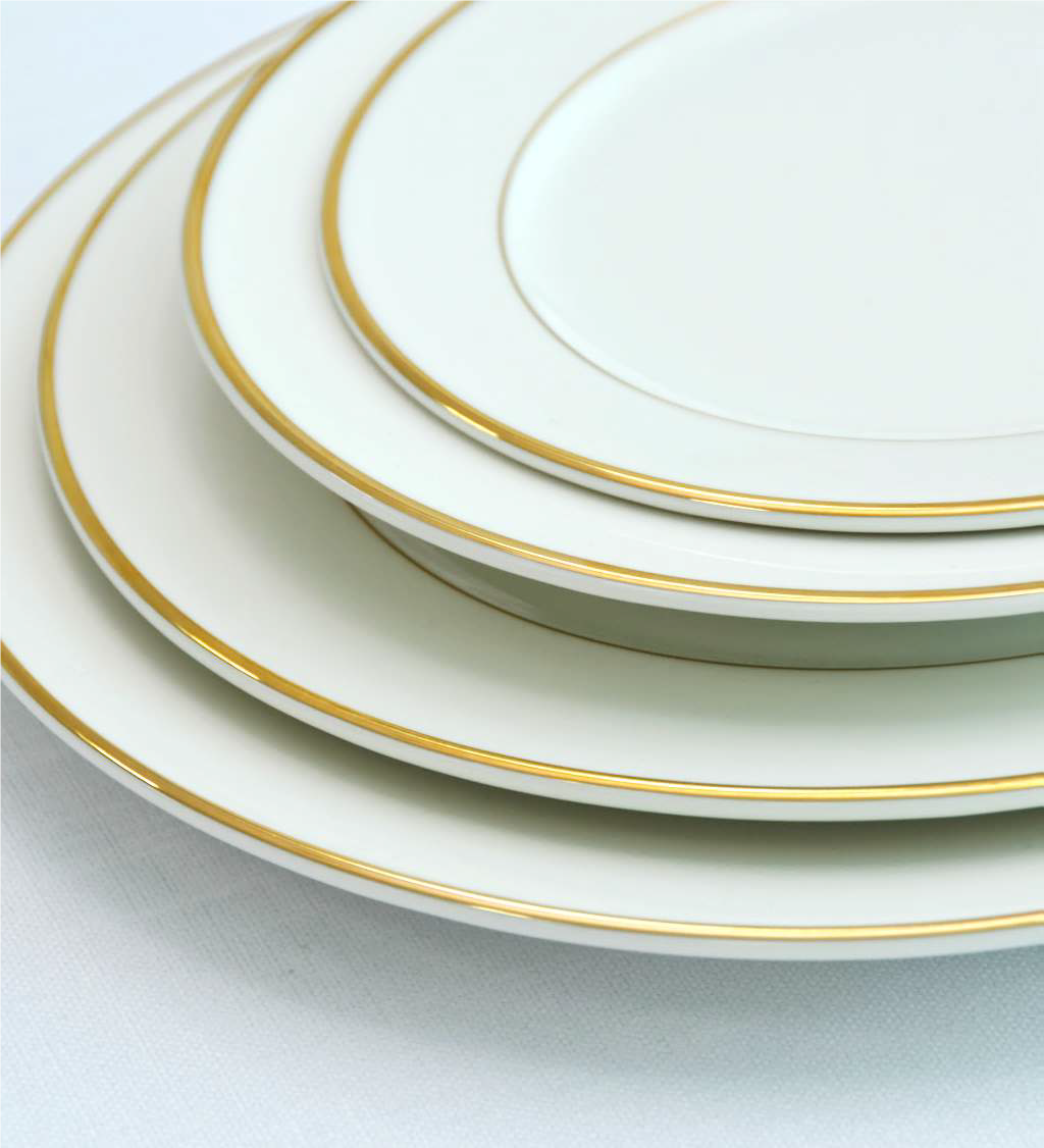 MODERN CHINA W/ GOLD RIM PLATES, a stack of elegant white plates with gold trim, ideal for enhancing premium events and functions.