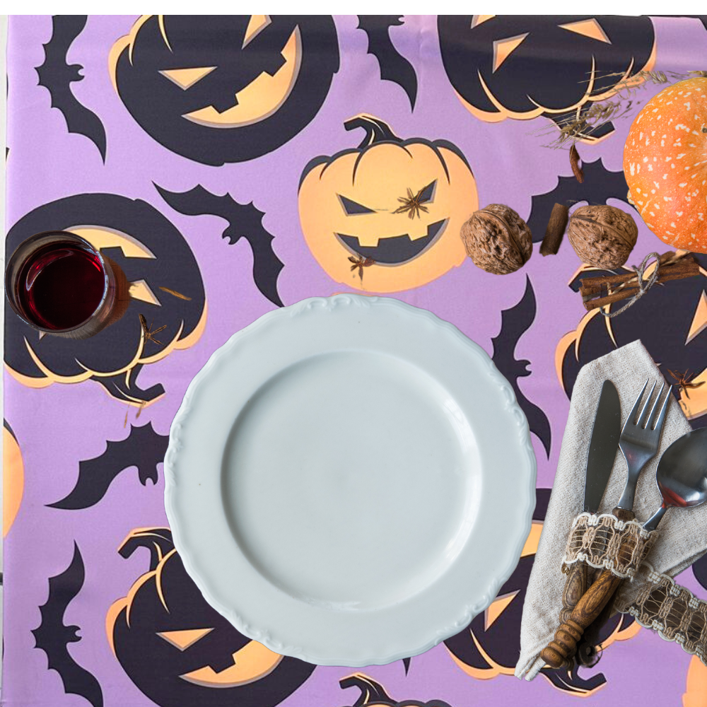 Pumpkin Ghost Bat Polyester Tablecloth featuring a whimsical Halloween design on a table set with matching tableware, perfect for enhancing your festive party decor.