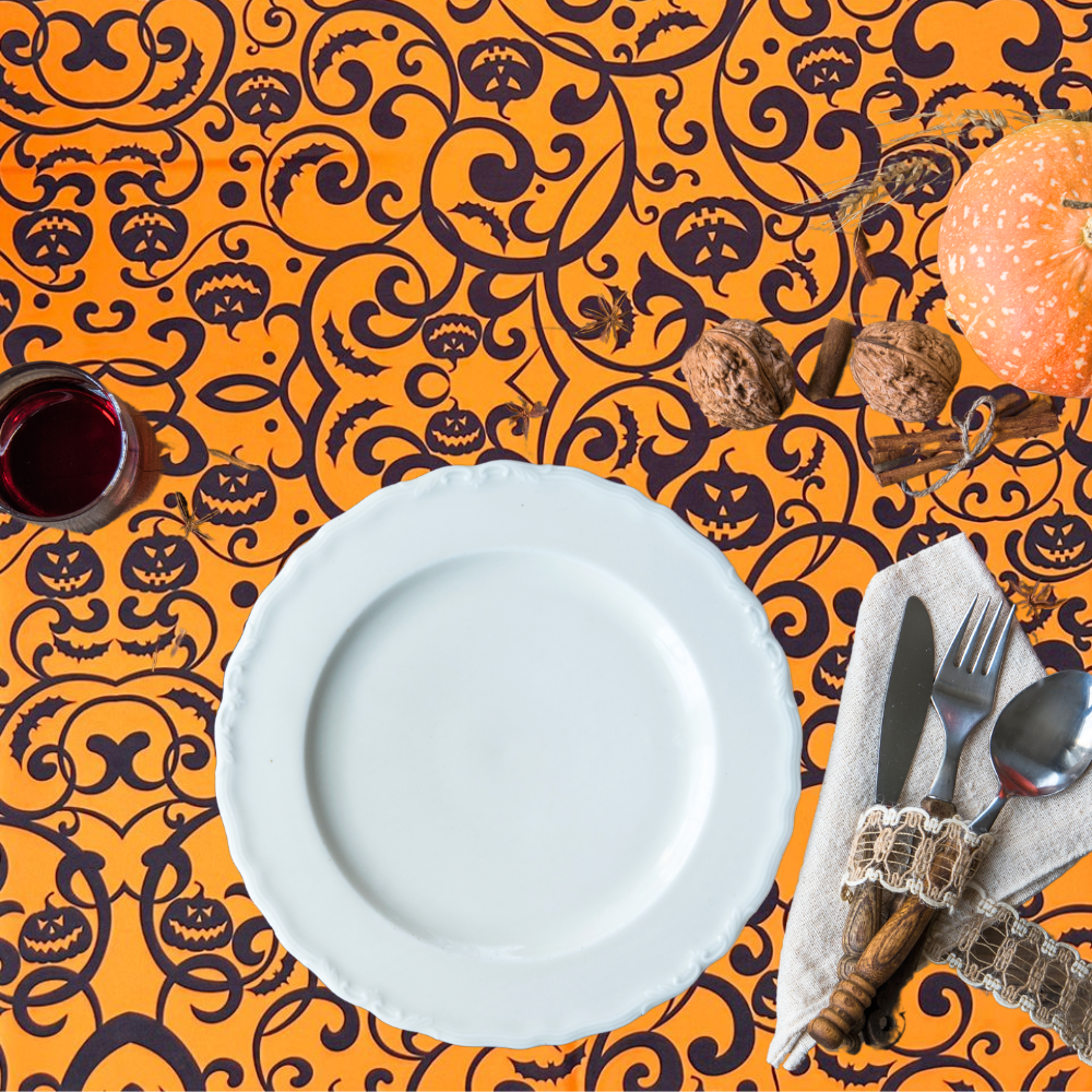 Gothic Pumpkin Polyester Halloween Tablecloth on display with a place setting, featuring silverware and a napkin, perfect for themed gatherings.