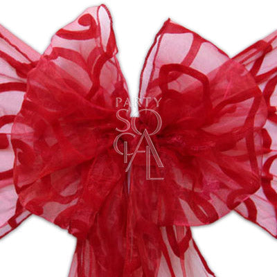 CHAIR SASH SHEER ORGANZA with a red swirl-patterned bow, ideal for dressing up chairs at events.