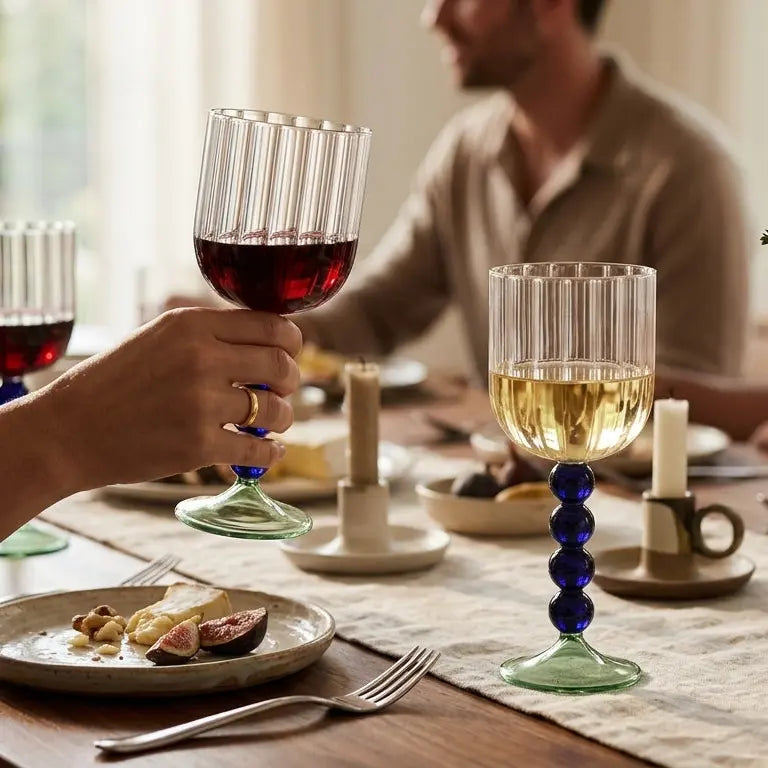 Two people at a dinner table with wine glasses and plates