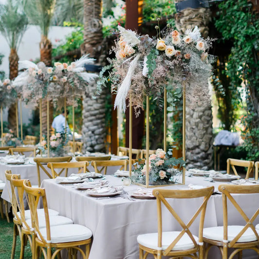 Rectangular Tablecloth Cotton Linen drapes elegantly over outdoor dining tables, adorned with gold-framed floral centerpieces, ready for a sophisticated event setup.