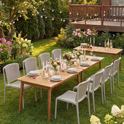 Outdoor dinner scene with LINED TAUPE CHAIR set around wooden tables, featuring elegant floral arrangements, candles, and place settings, under ambient string lights in a garden setting.