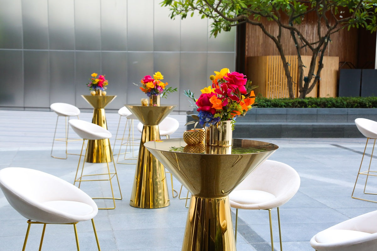 GOLD MIRROR COCKTAIL TABLES with elegant gold legs, adorned with a vase and flowers, ideal for enhancing any event&