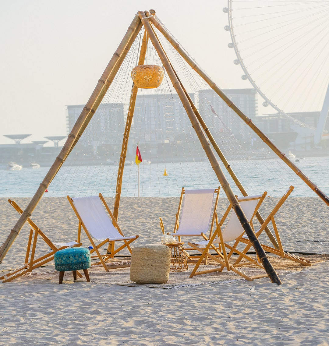 Wooden deckchairs on a beach, ideal for informal gatherings and enhancing outdoor cinema experiences, available for rental or sale at Party Social.