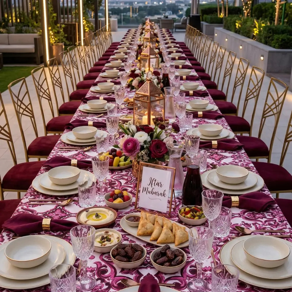 Majolica Rectangular Tablecloth elegantly drapes a long iftar table, adorned with gold-accented settings, floral decor, and Iftar Mubarak sign, perfect for festive gatherings.