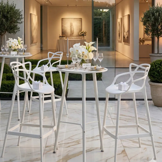 MASTERS STOOL WHITE REPLICA in an elegant event setup with tall bar tables, floral arrangements, candles, and gold flatware, perfect for sophisticated cocktail gatherings.
