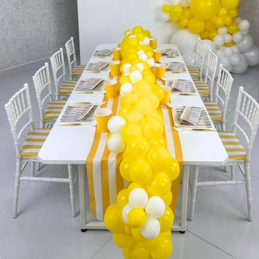 Mini Chiavari Chair with Yellow Stripes Cushion displayed beside a table with balloons, ideal for children's parties and event settings.