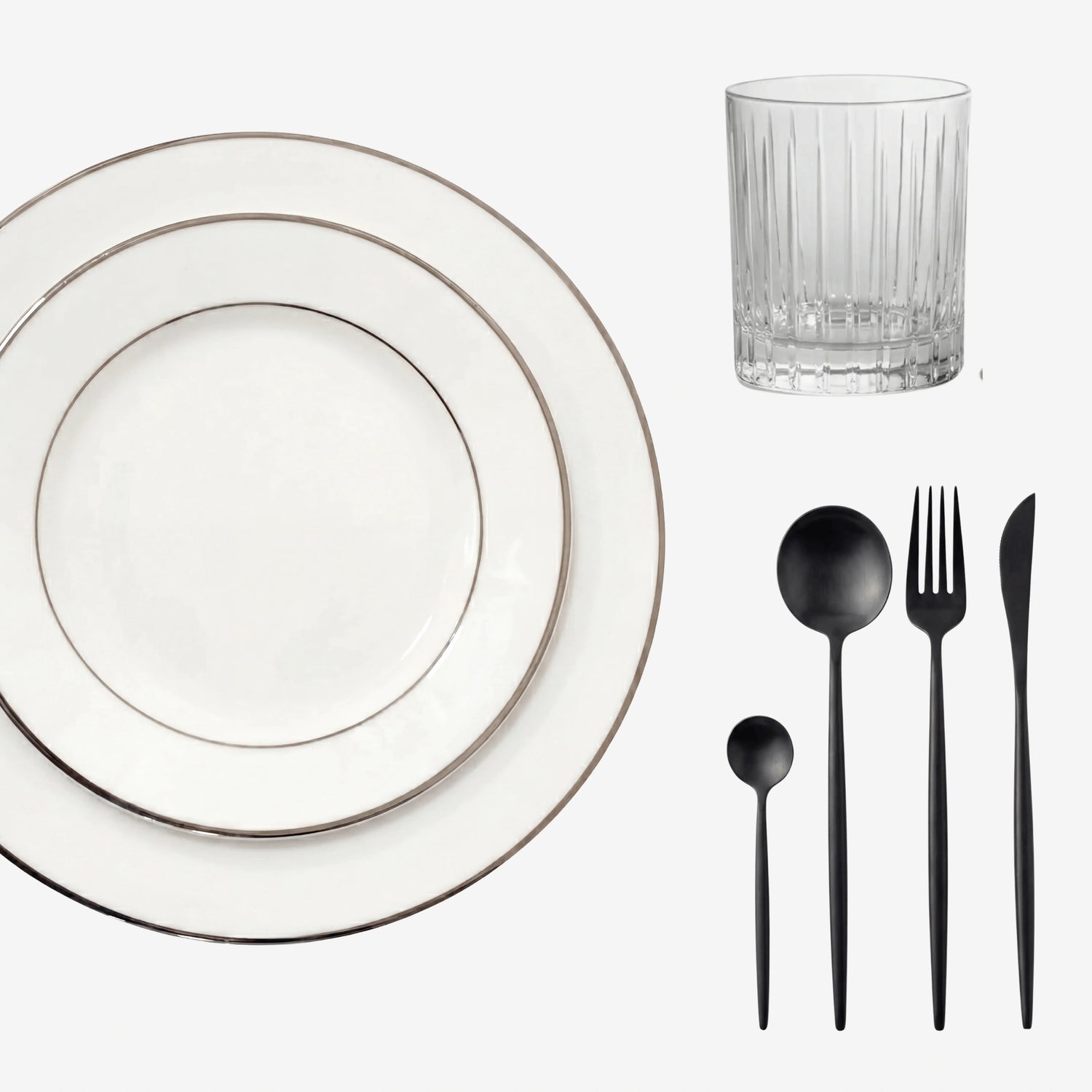 Minimalistic Tabletop Package featuring white plates with silver rims, a faceted tumbler, and matte-black flatware, perfect for elegant dining settings.