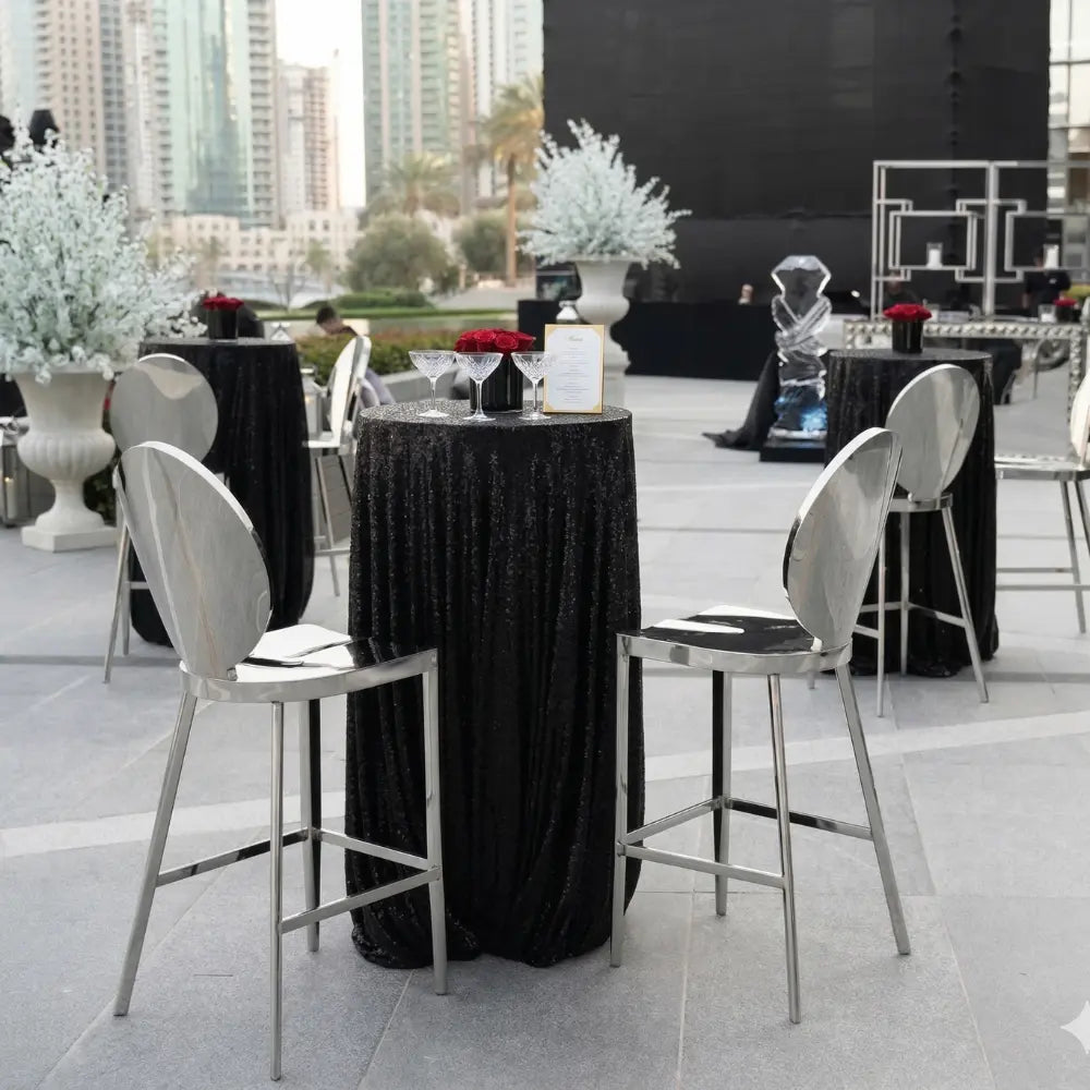 Mirrored Silver Barstool at an elegant cocktail reception, featuring a sleek design perfect for upscale events, paired with a black sequined table and red rose centerpiece.