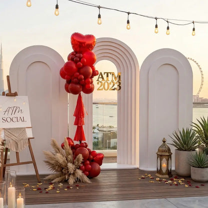 Molded Frame Backdrop featuring a white, triple-arched design with ATM 2023 in gold, surrounded by balloons, pampas grass, and decorative elements for event elegance.