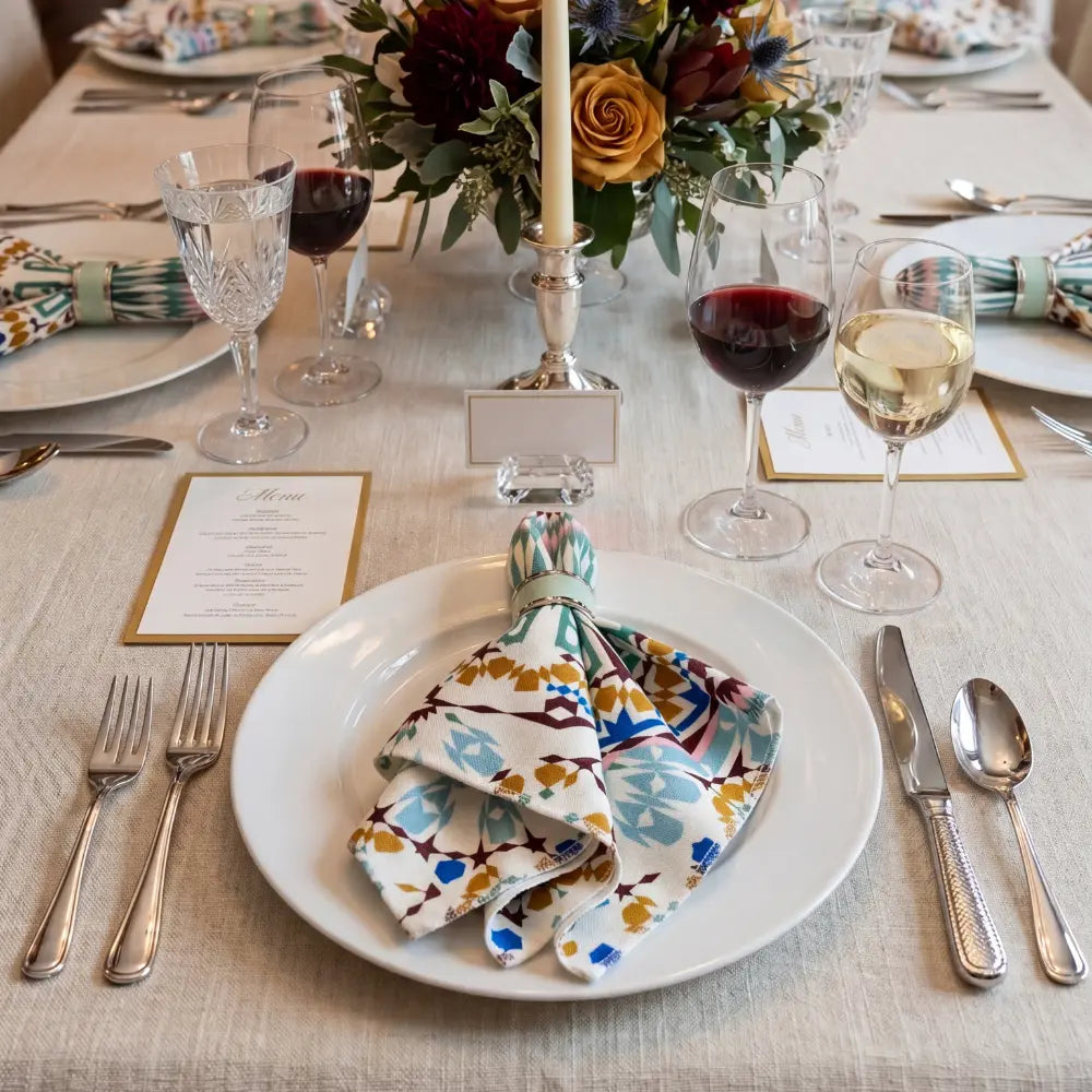 Moroccan Polyester Linen Napkin with kaleidoscopic mandala pattern, showcasing rich earthy tones, neatly folded. Ideal for stylish table settings at parties or events.