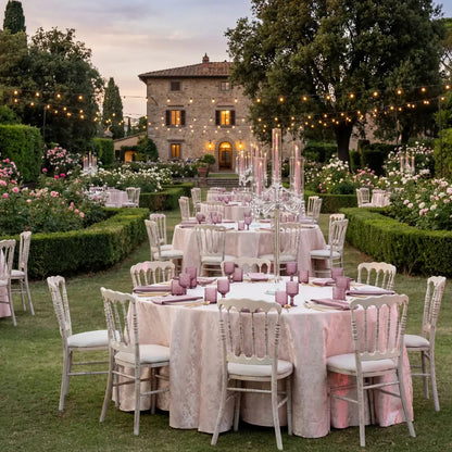 Napoleon Creamwash Chair in elegant garden reception setting, featuring white round tables, blush linens, gold-tone flatware, and candelabra centerpieces, perfect for chic events.