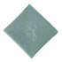 NAPKIN COTTON LINEN, folded square with a stitched logo, ideal for events. Premium cotton for versatile use at parties or corporate gatherings.