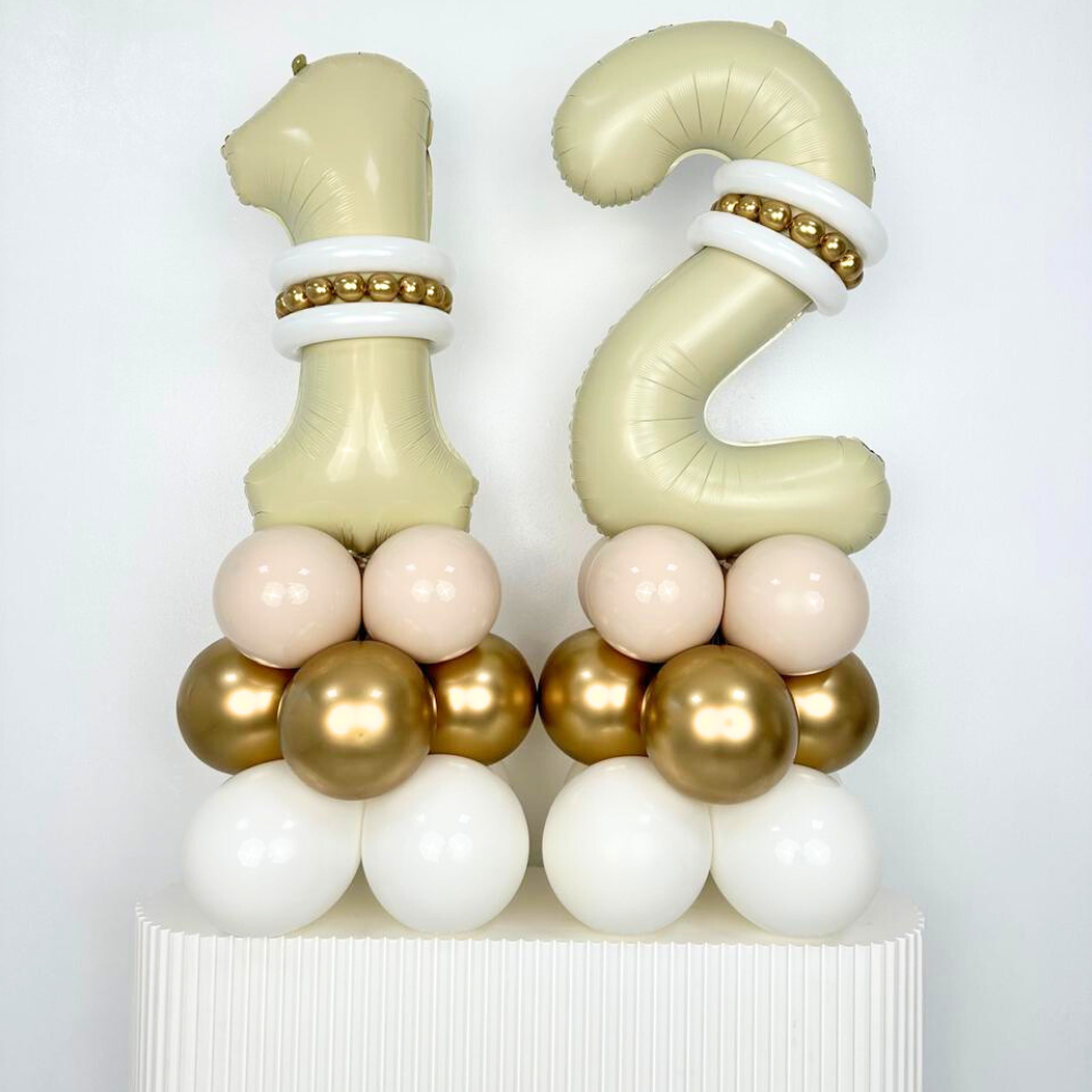 Duo Ivory Foil Number Balloon Stack featuring cream and chrome gold balloons arranged on a pedestal, ideal for table or floor decoration at events.