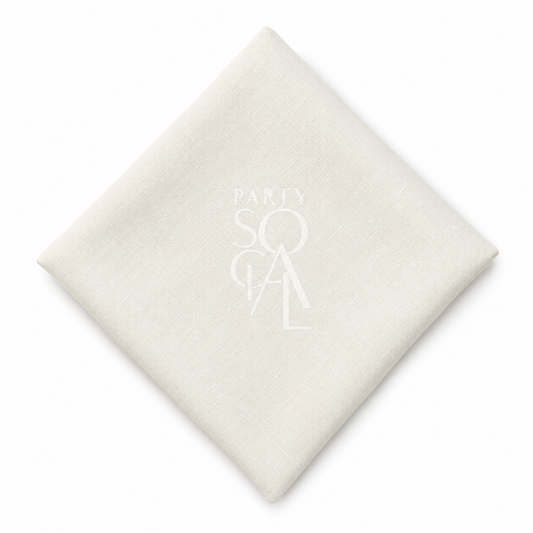 A square off white linen napkin displayed diagonally on a clean white background.
