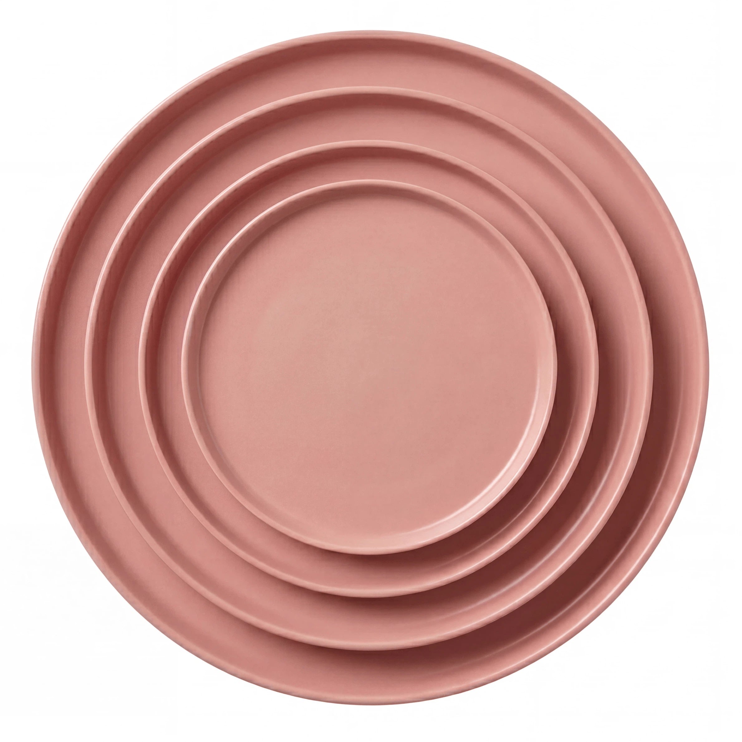 CERAMIC PLATES - PINK: A nested set of four blush-pink ceramic plates in graduated sizes, perfect for enhancing any table setting.