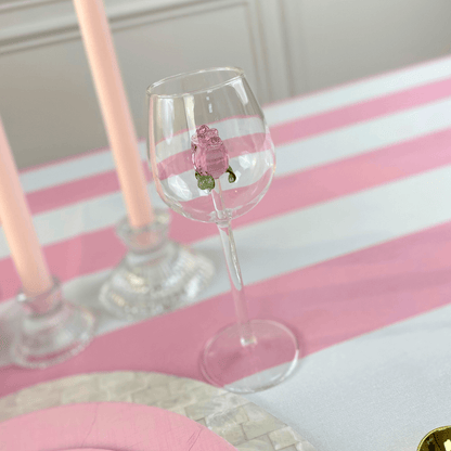 A glass with a rose charm, ideal for events and themed parties, adding a colorful touch to table settings. Perfect for weddings, dinner parties, and special occasions. From Party Social.