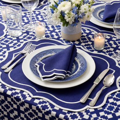 The Iftar Table Edit Gift Box featuring a formal place-setting with elegant navy and white linens, decorative plates, and a refined floral centerpiece.
