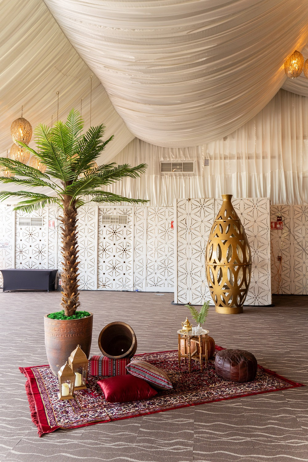 Outdoor Pot displayed in an indoor setting with a palm tree, showcasing its versatile design for enhancing both event and home spaces.