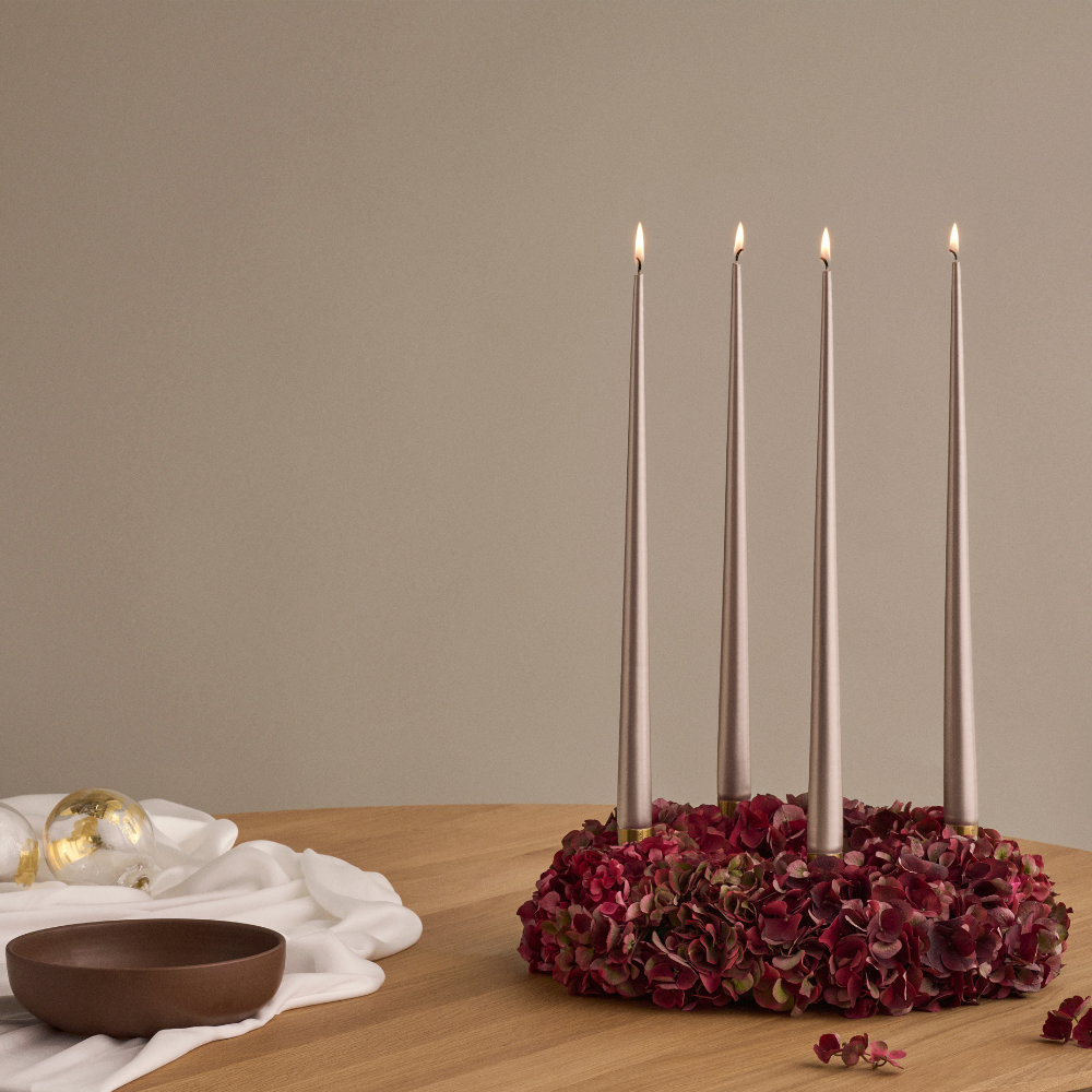 Tapered Smokeless and Dripless Metallic Candles, 42cm, elegantly displayed in a candle holder, ideal for creating a warm ambiance at events or parties.