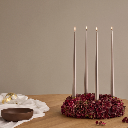 Tapered Smokeless and Dripless Metallic Candles, 42cm, elegantly displayed in a candle holder, ideal for creating a warm ambiance at events or parties.