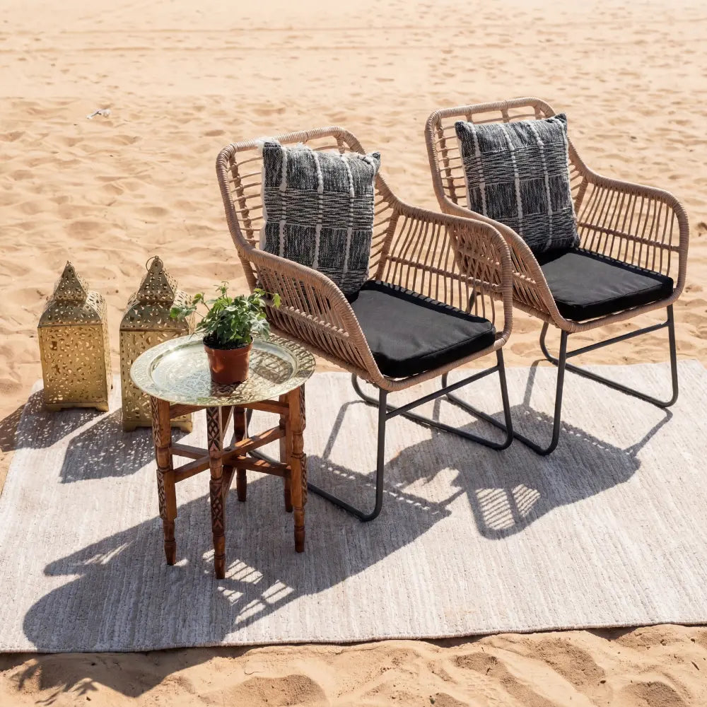 RATTAN SINGLE SEATER shown in a beach setup with cushions and a side table, ideal for outdoor events.