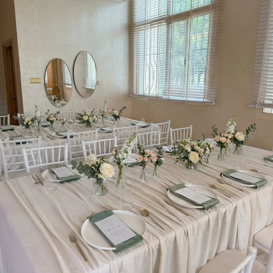 Rectangular Tablecloth Velvet elegantly draped over banquet tables with chiavari chairs, featuring sage-green napkins and floral arrangements, enhancing any event's aesthetic.
