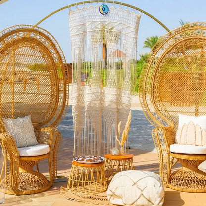 Round Gold Arch in a boho-style outdoor seating area with macramé, wicker chairs, and decorative accents, suggesting a serene event backdrop.