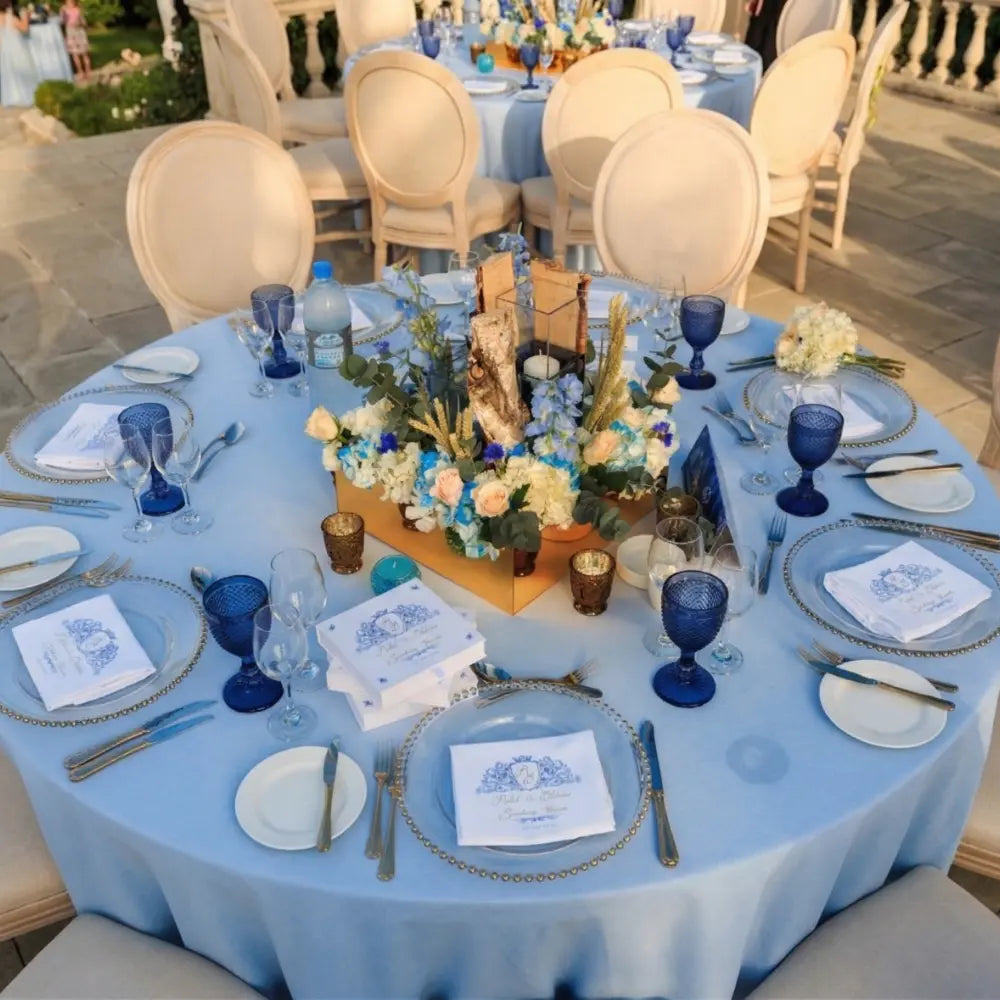 Elegant round table set with ROUND TABLECLOTH COTTON LINEN, featuring a birch-bark floral centerpiece, gold-edged chargers, and full place settings for an upscale event.