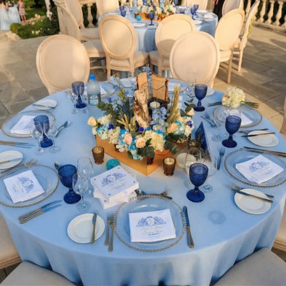 Elegant round table set with ROUND TABLECLOTH COTTON LINEN, featuring a birch-bark floral centerpiece, gold-edged chargers, and full place settings for an upscale event.