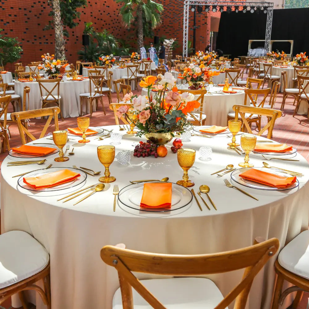ROUND TABLECLOTH LINEN BLEND displayed on a set table with gold flatware and floral centerpiece, highlighting its elegant texture and suitability for formal events.