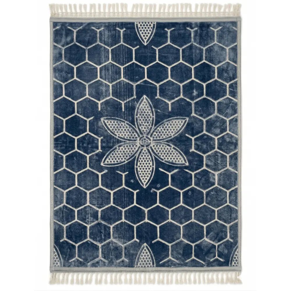 RUG BLUE SELF PRINT: Navy-blue rug with white hexagon grid and central flower motif, accented by tassel fringes, ideal for elevating any event setting.