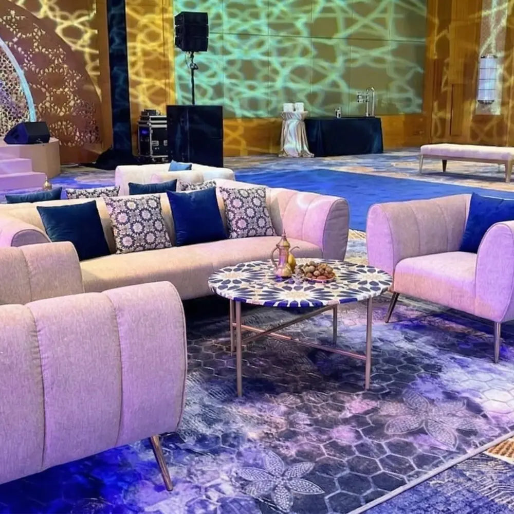 RUG BLUE SELF PRINT enhances the plush seating area with its rich hexagonal and floral patterns, perfect for upscale event settings by Party Social.