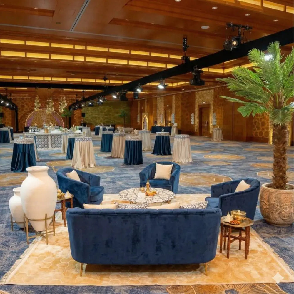 RUG SAND SELF PRINT underlines the luxurious lounge setup with its rich self-print design, complementing the upscale cocktail event ambiance.