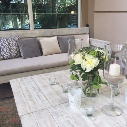 RUSTIC COFFEE TABLE: A whitewashed wooden table with elegant decor, part of the Party Social collection, ideal for stylish events and gatherings.