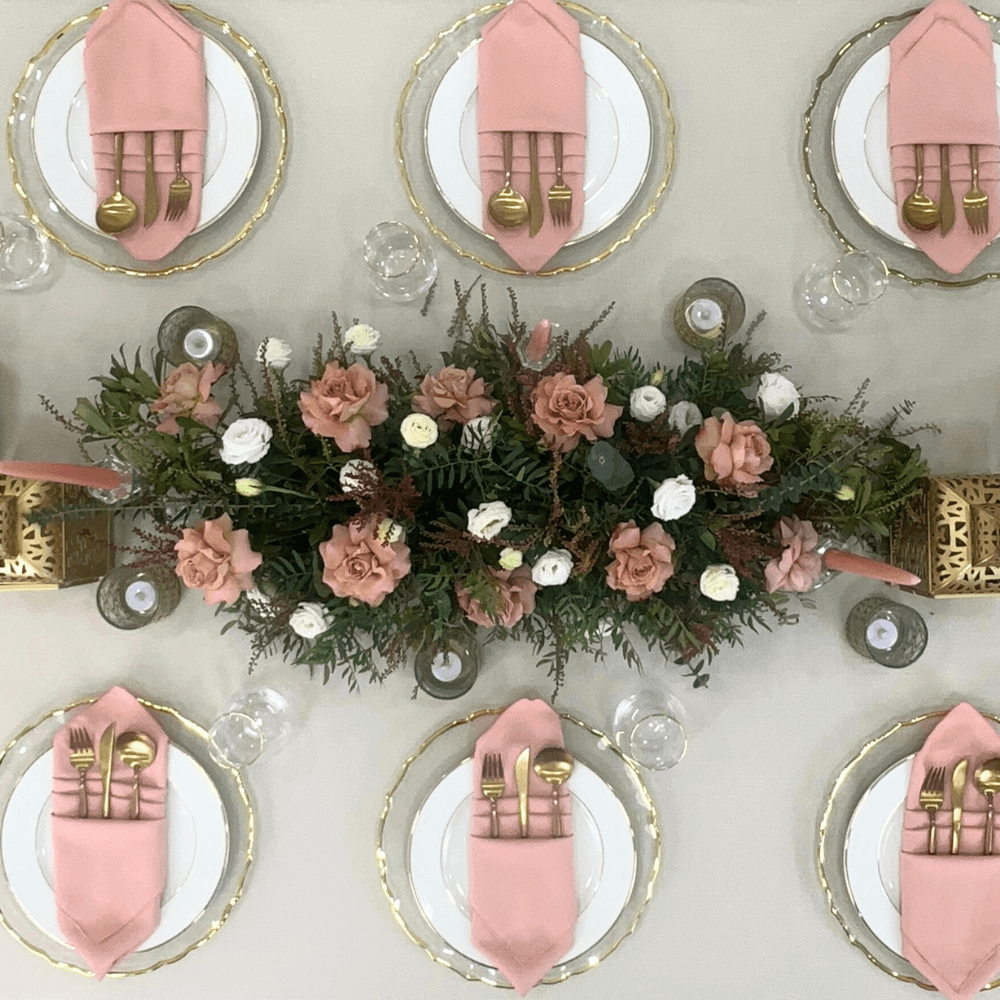 Ramadan Luxe- Dining Setup featuring a table elegantly set for eight with gold cutlery, plates, napkins, glassware, and decorative lanterns and candle holders.