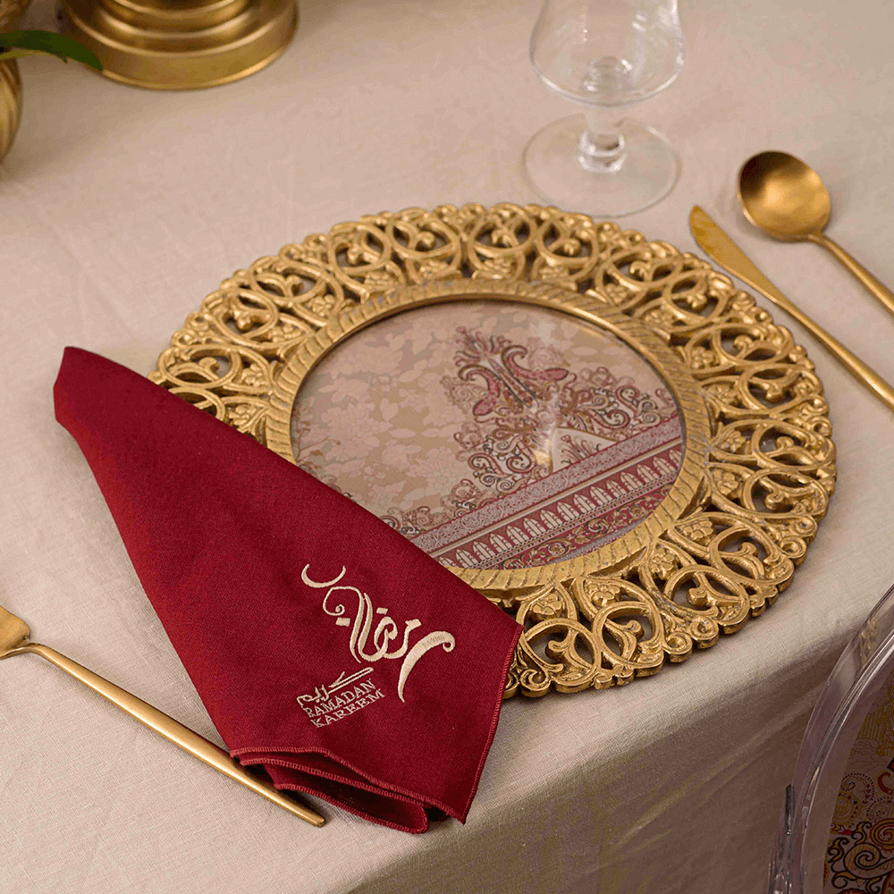 Vintage Arabesque - Dining Setup: A gold plate with napkin and spoon on a table, part of a complete dining set for 8 guests.