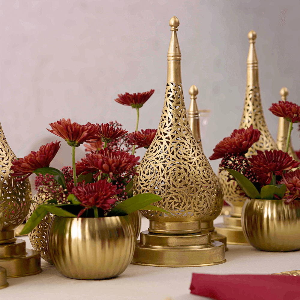 Vintage Arabesque Dining Setup featuring gold vases with red flowers, brass table lamps, and floral centerpieces, designed for elegant party settings.