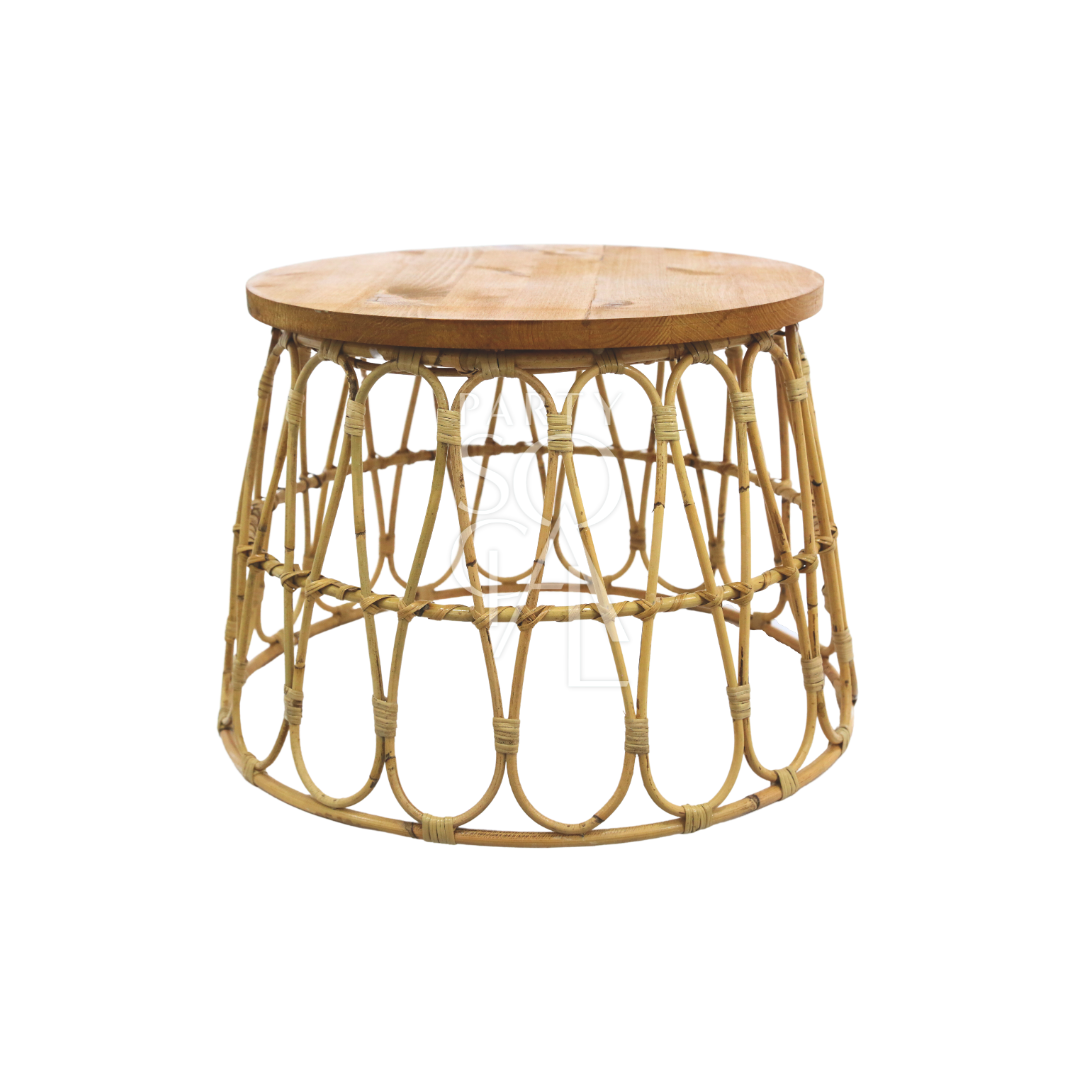 RATTAN COFFEE TABLE: A round wooden table topped with a woven basket, perfect for corporate events and home functions, suitable for rental or purchase at Party Social.