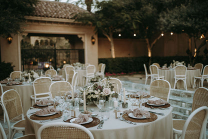 RATTAN CHAIRS set around a dining table, ideal for weddings and events, showcasing vintage style with a focus on party and event rentals.