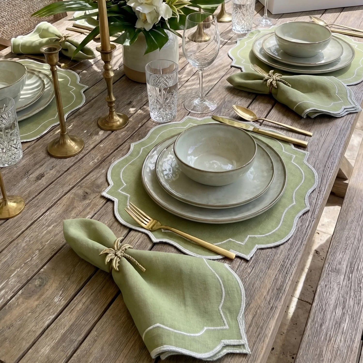 Rustic table setting with Brass Palm Tree Napkin Ring, part of a 6-pack, elegantly enhances a tropical-themed dining experience.