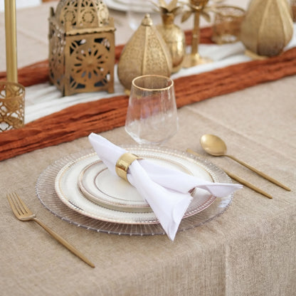 The Golden Desert - Dinner Setup featuring elegant plates, gold flatware, lanterns, and a runner on a linen tablecloth, designed for eight guests by Party Social.