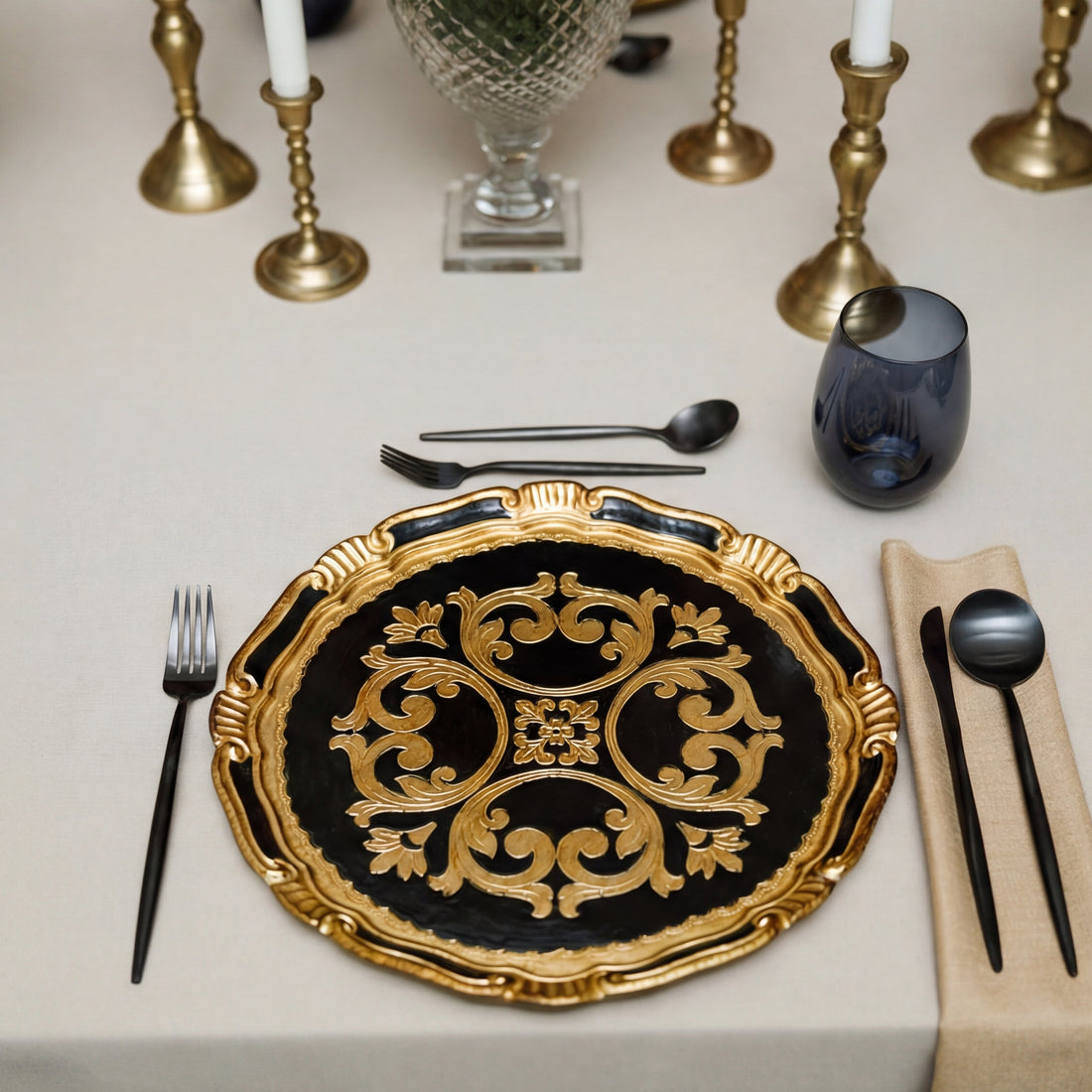 Formal table setting featuring The Midnight Majlis Collection with a black and gold charger, cutlery, linen napkin, and blue tumbler, ideal for refined Ramadan gatherings.